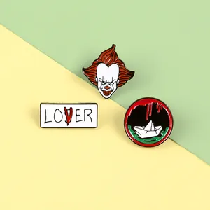 Detailed enamel pins of Pennywise clown head, Lover text sign and red paper boat set