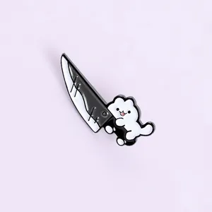 Detail of cute enamel pin featuring a white cat holding a large black knife on purple background
