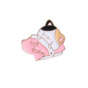 Detailed macro view of the Not Today cartoon cat enamel pin with a pink pillow design