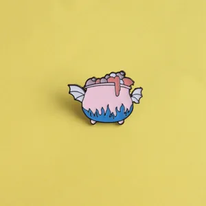 Cartoon winged pink magic cauldron enamel pin with blue flames and purple bubbles