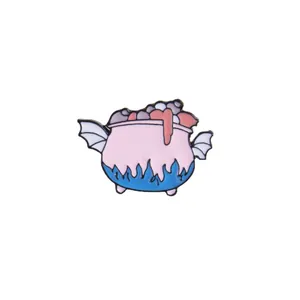 Detail of pink and blue enamel potion cauldron brooch with bat wings and magic flames