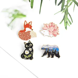Set of 4 creative enamel pins featuring fox, hedgehog, cat and bear with floral details