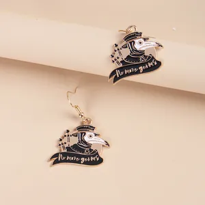Quirky plague doctor hook earrings with No More Germs banner on a minimalist pedestal