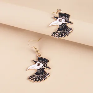 Creative plague doctor drop earrings with bird mask design and gold enamel finish