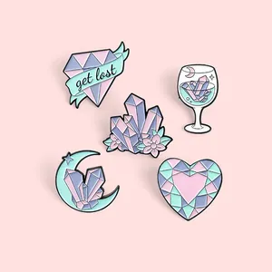 Set of five pastel enamel pins featuring a diamond heart, crescent moon, and crystal wine glass