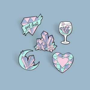 Detailed set of crystal and moon enamel pins in pastel colors with macro metal finish