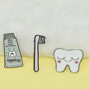 Cute cartoon tooth toothpaste and toothbrush enamel pin set on soft plush background