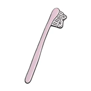 Detailed macro view of a cute cartoon pink toothbrush enamel pin with white foam accents
