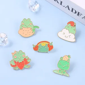 Detailed set of five cute frog enamel pins with strawberry and rainbow designs