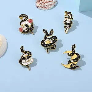 Set of five black and gold snake enamel pins with celestial and floral gothic motifs