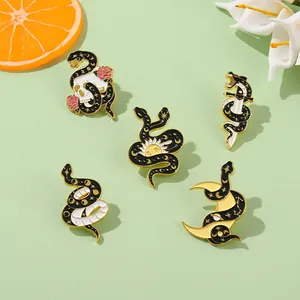 Five-piece mystic snake enamel pin set with skull and moon designs on green background