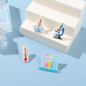 Detailed close-up of colorful enamel science pins featuring microscope and laboratory tools