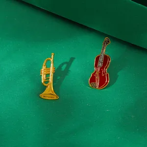 Dettaglio di spille vintage a forma di strumenti musicali in smalto chitarra e violino