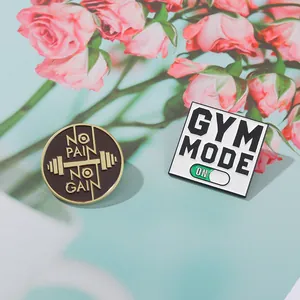 Detail of alloy GYM MODE and NO PAIN NO GAIN enamel pins for fitness enthusiasts