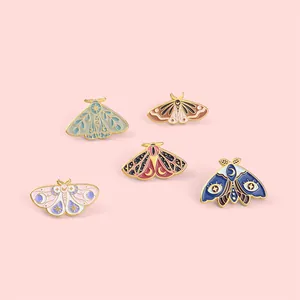 Lot de cinq épingles papillon en émail bohème avec détails lune et étoiles sur fond rose