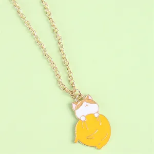 Cartoon orange tabby cat holding yellow fruit pendant on gold chain necklace