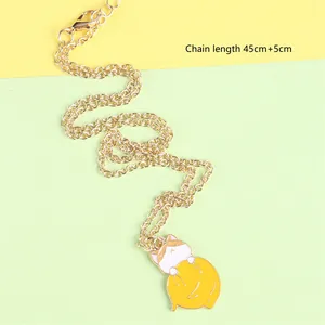 Detailed view of cat pendant on golden chain with lobster clasp and extension