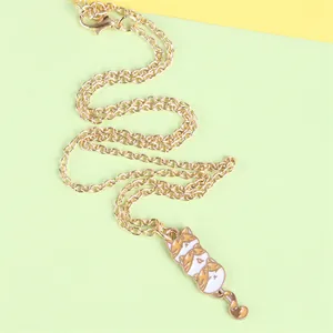 Detail of cute cat pendant necklace with enamel kittens and golden link chain