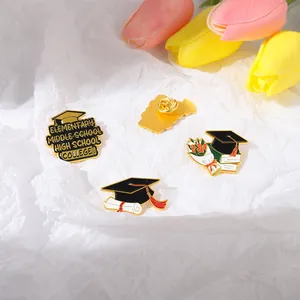 Detailed view of enamel graduation brooch set with cap and school level lettering