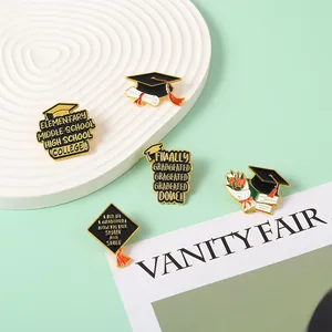 Macro view of graduation enamel pins featuring doctoral caps and floral bouquet motifs