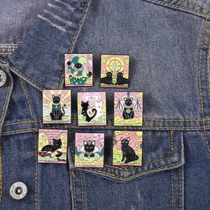 Eight unique black cat tarot enamel pins displayed on a blue denim jacket pocket