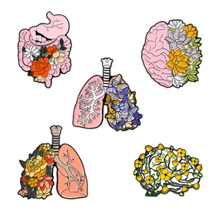 Artistic pink human organ enamel pins set featuring brain, lungs, and floral heart designs