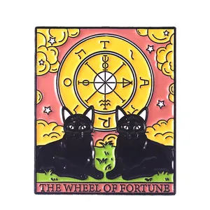 Detail of The Wheel of Fortune tarot enamel pin featuring black cats and golden moon