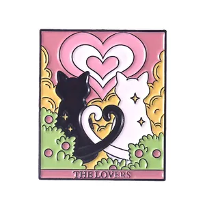 Detailed view of The Lovers tarot enamel pin featuring black and white cats heart motif