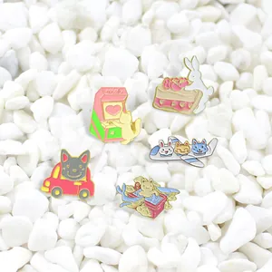 Macro view of five colorful enamel pins featuring cute animals like cat and rabbit
