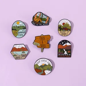 7-piece set of outdoor adventure enamel pins featuring mountain and camping designs