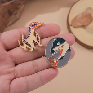 Cute enamel dinosaur brooch set and cartoon girl with dragon pin in hand