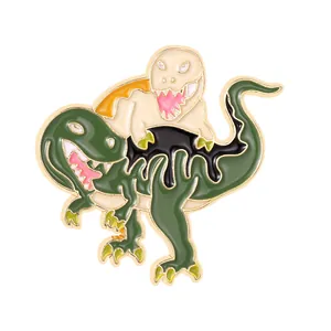 Detail shot of a creative green and yellow enamel dinosaur pin with gold plating
