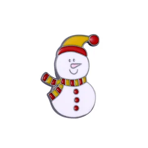 Detail of cute snowman enamel brooch with yellow hat and red scarf for Christmas