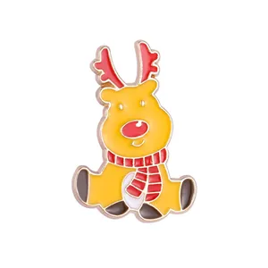 Detailed view of reindeer enamel brooch with red antlers and striped holiday scarf