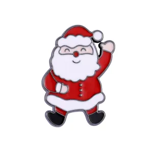 Detail of waving Santa Claus enamel brooch with vibrant colors for Christmas decoration