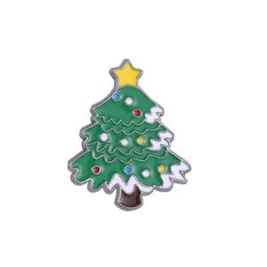 Macro detail of Christmas tree enamel brooch with colorful dots and yellow star on top