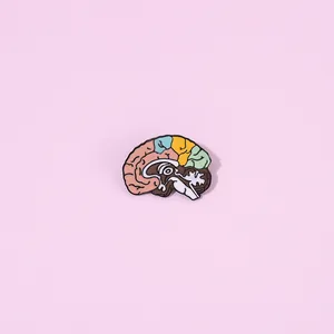 Macro detail of a colorful human brain anatomy enamel pin with vibrant epoxy color blocks
