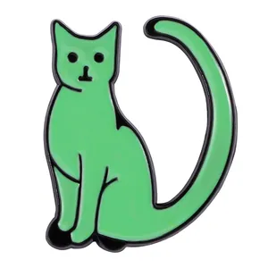 Close-up of a light green enamel cat brooch with black outlines and long tail detail