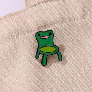 Cartoon green frog chair enamel pin accessory for backpacks and creative clothing decor
