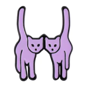 Detail shot of purple twin cat enamel pin with polished metal edges for clothing