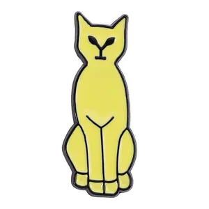 Close-up of a yellow cat enamel brooch with black metal outlines and sharp eyes