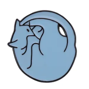 Detail of a light blue enamel cat badge in a sleeping pose with minimalist metal outline