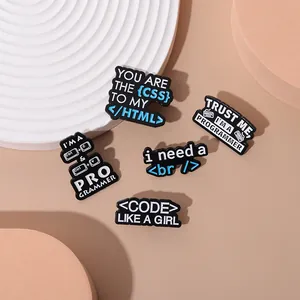 Close-up of 5-piece programmer enamel pins set with HTML CSS coding labels and key icons