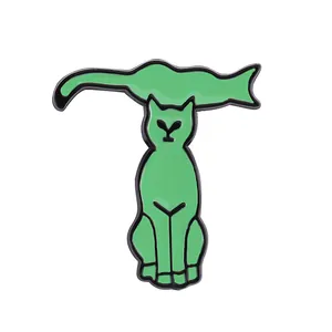 Detail of creative green cat enamel pin badge forming the English letter T shape