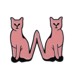 Detail of pink cat enamel pin in W shape crafted from polished alloy for bags