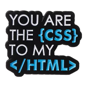 Detail of metal enamel programmer brooch with YOU ARE THE CSS TO MY HTML text design