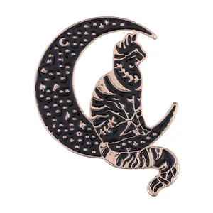 Detail of enamel moon and cat brooch featuring golden edges and starry texture