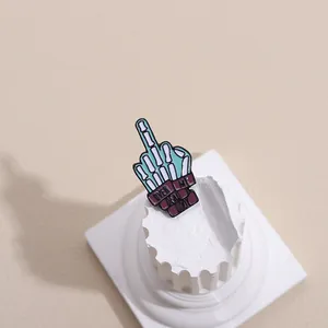 Detail of mint green skeleton hand enamel pin with 'Over My Dead Body' quote