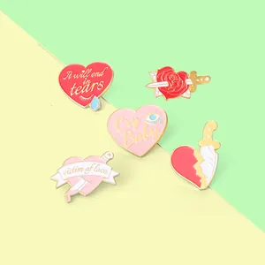 5-piece set of enamel pins featuring heart, dagger, and rose designs with gold metal outlines