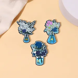 Three-piece set of cartoon enamel pins featuring floral arrangements in lab flasks